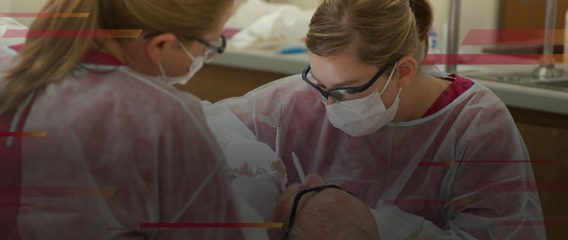 students cleaning a patient's teeth