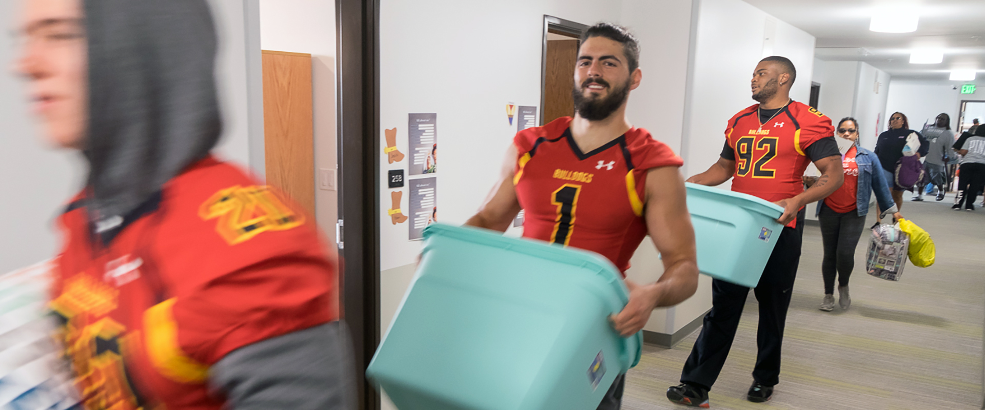 Ferris State University football players helping students moving into their residence hall