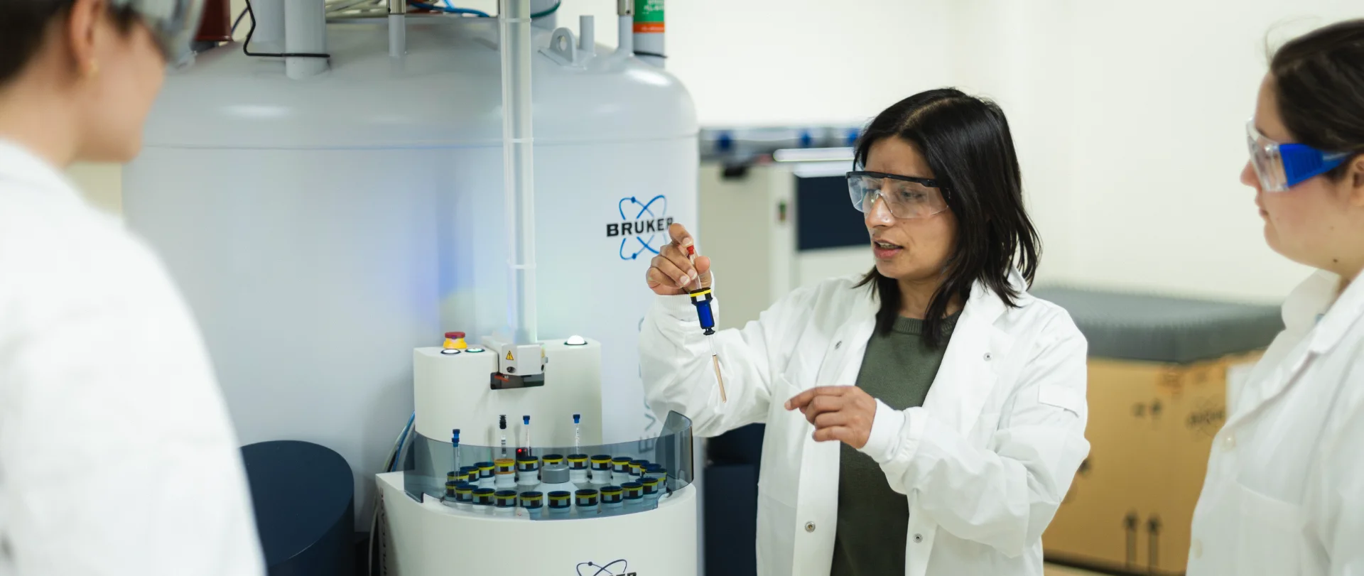 Student adding samples to lab equipment