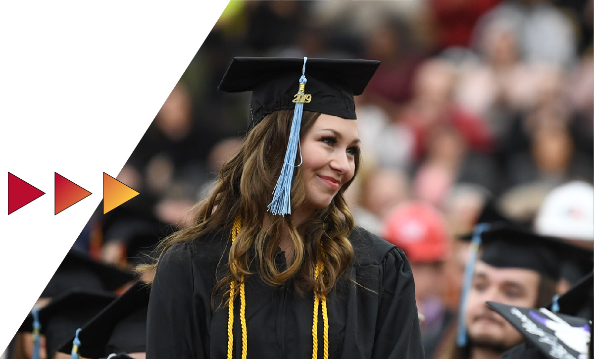 Student standing at a commencement ceremony
