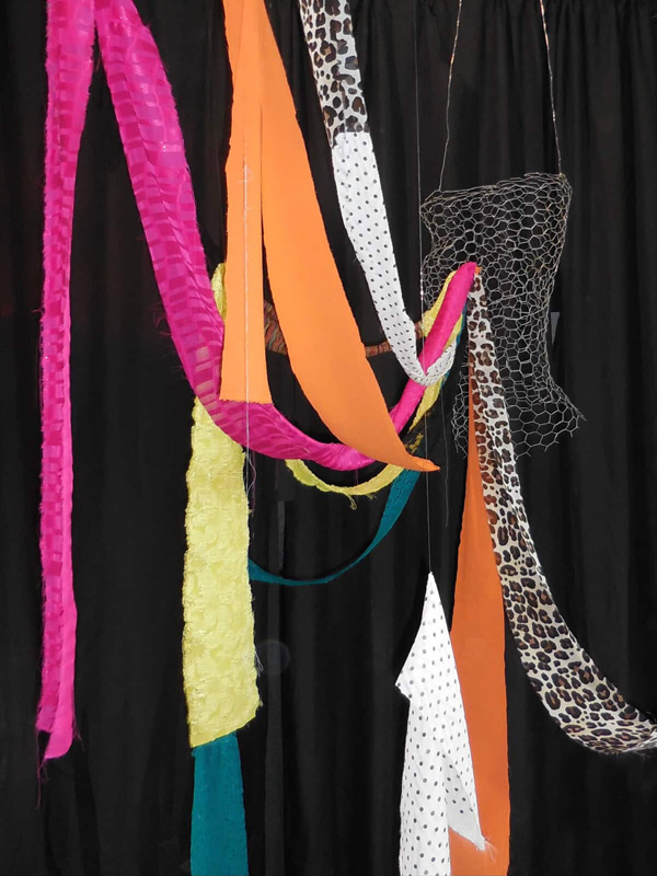 colorful clothes draped from the ceiling