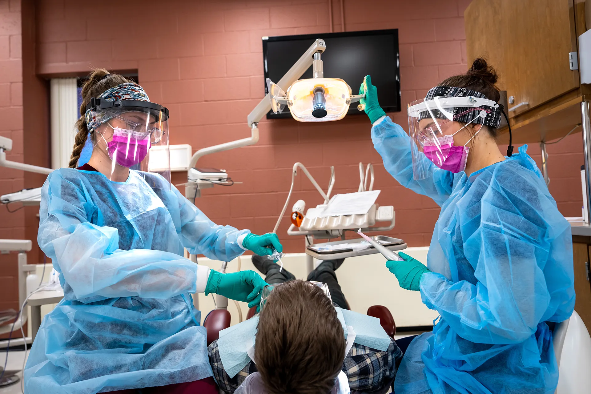 Two dental hygienists with a patient