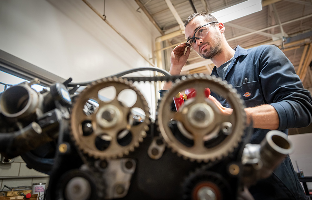 Student working with a combustion engine