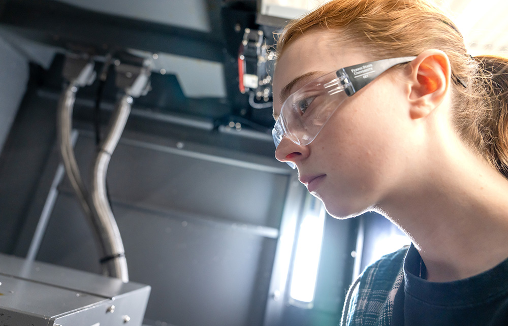 Student working with manufacturing equipment