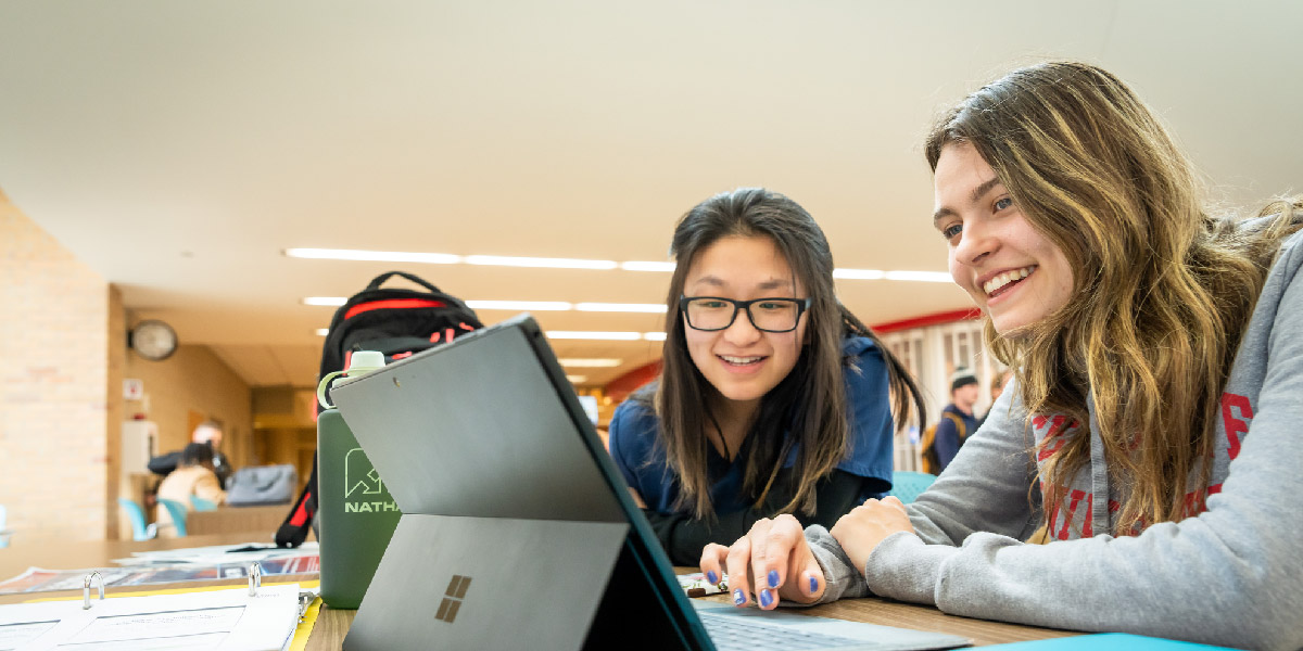 Students working on a laptop.