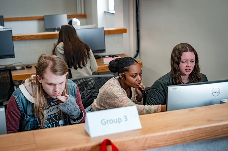 Students working with computers in a classroom setting