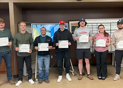 Students holding their Lean Six Signma Certification certificate