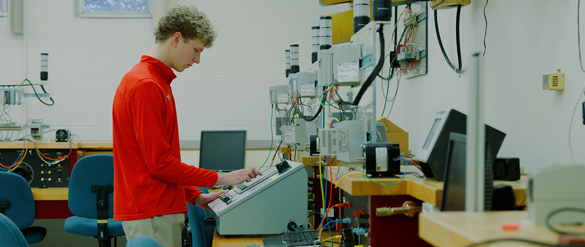 Ferris State University Electronics Automation Engineering Technology student studying equipment in a lab.