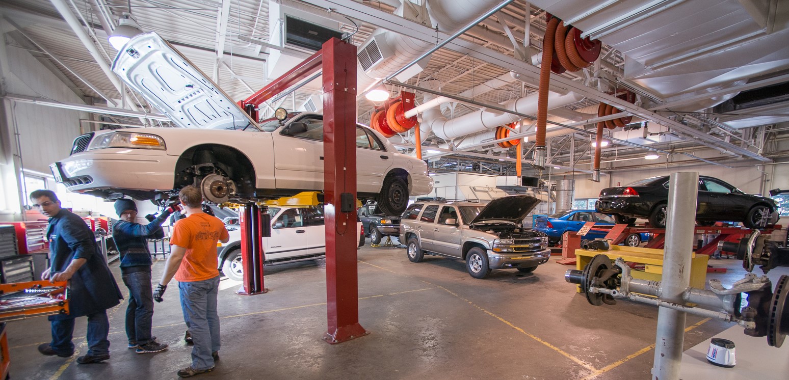 Students working in the automotive service floor