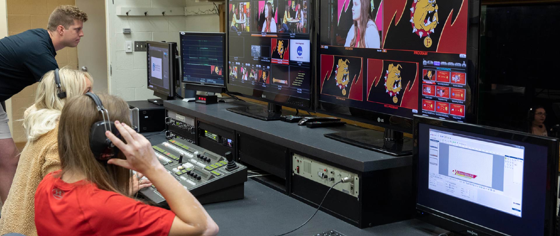 Students working in broadcast booth