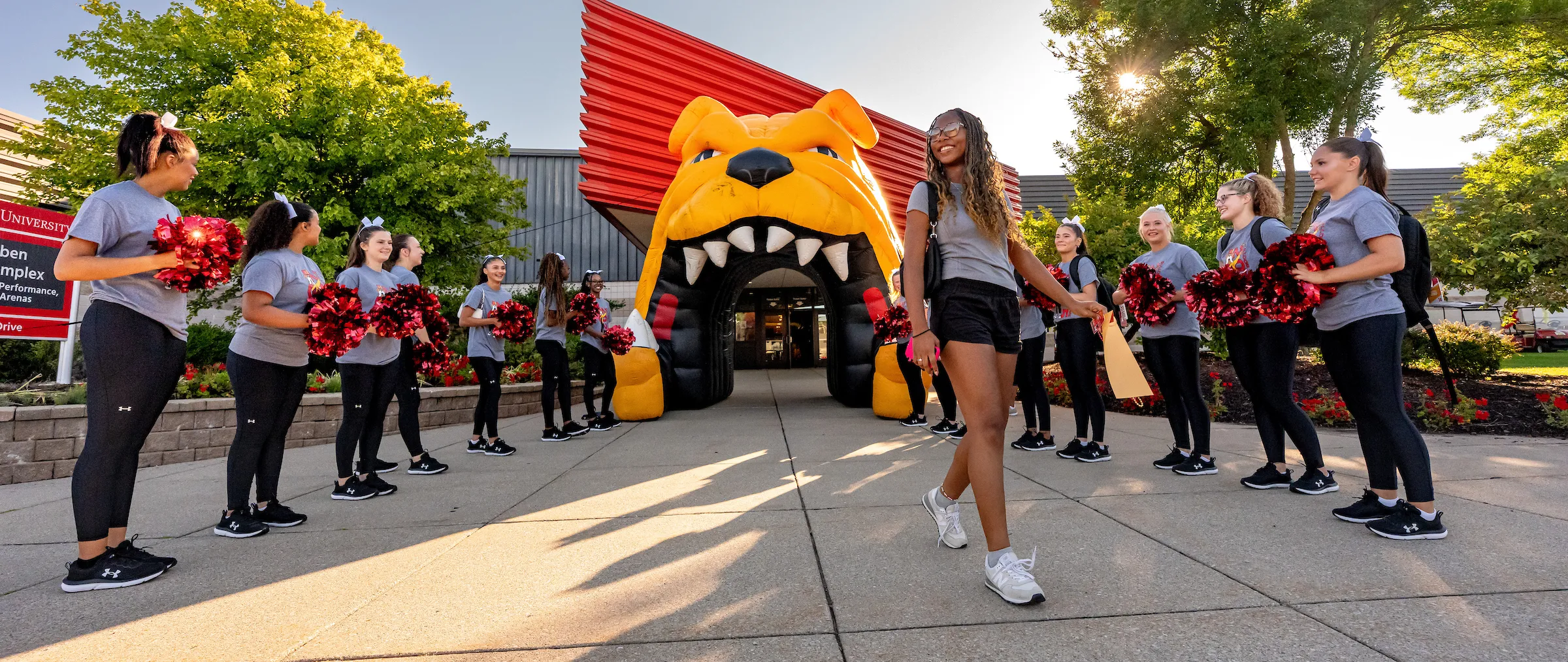 stunt and cheer team welcoming students to campus on move-in day