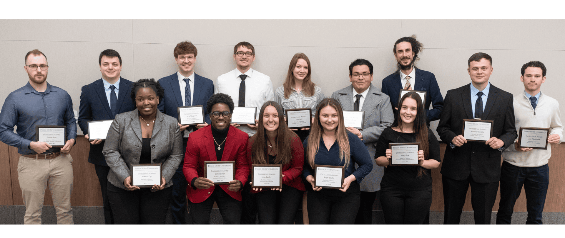 Multiple students holding awards