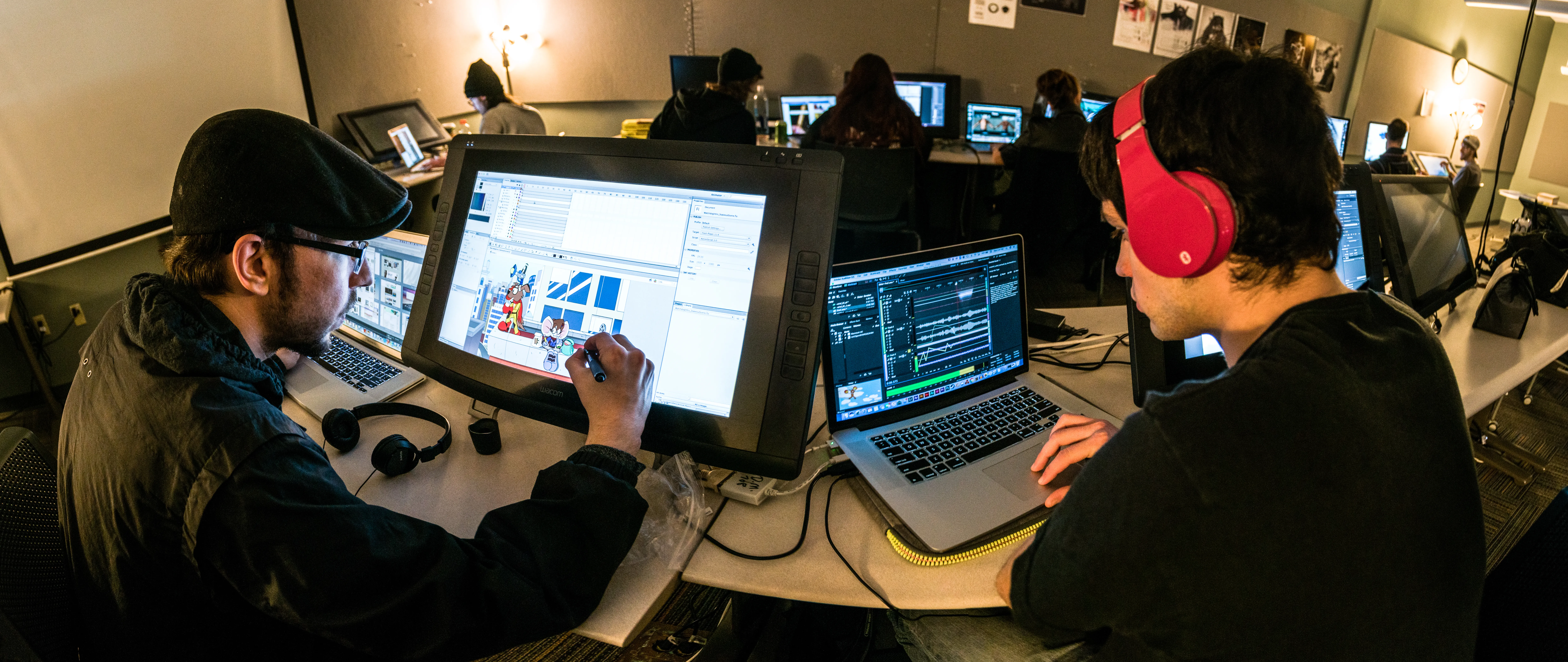 student working at a computer on digital art