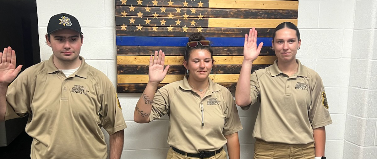 Emma Bleecher (right) among those being sworn in by the Mecosta County Sheriff's Office.