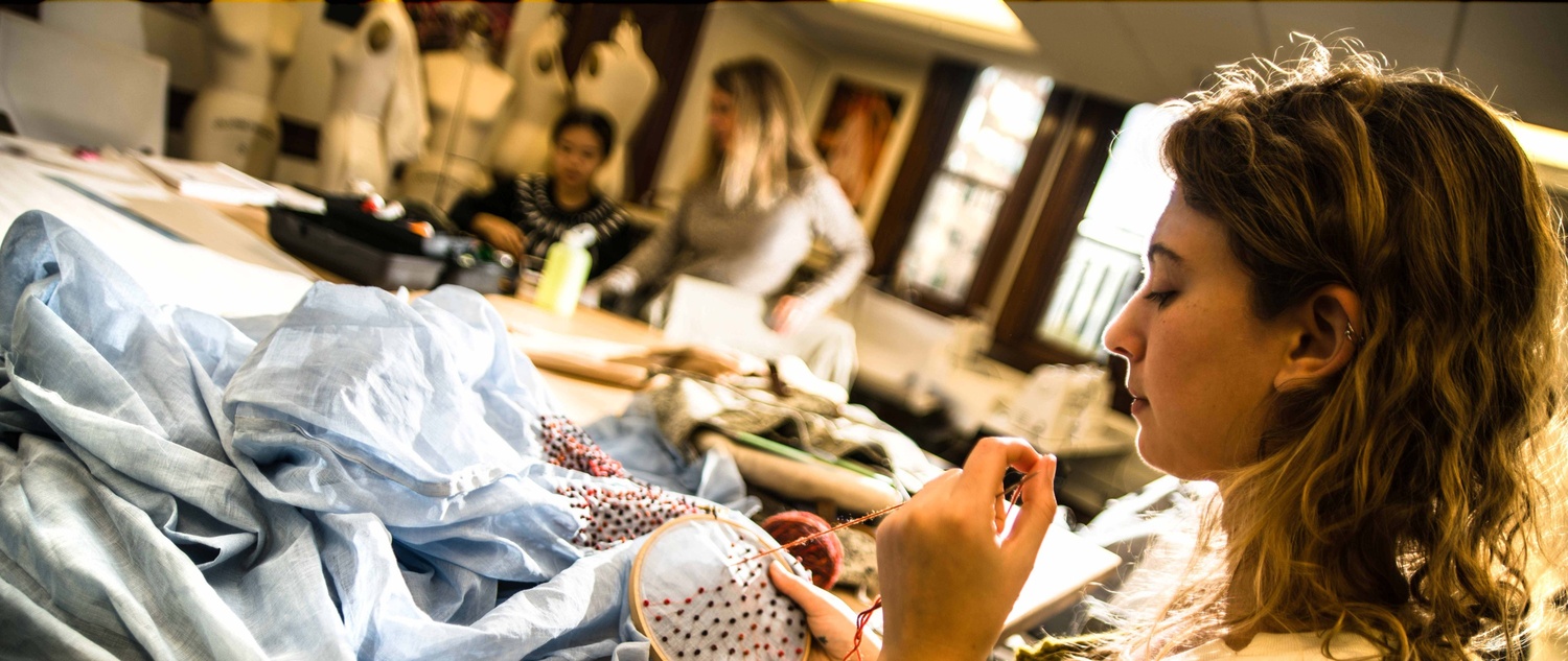 Student designing a dress