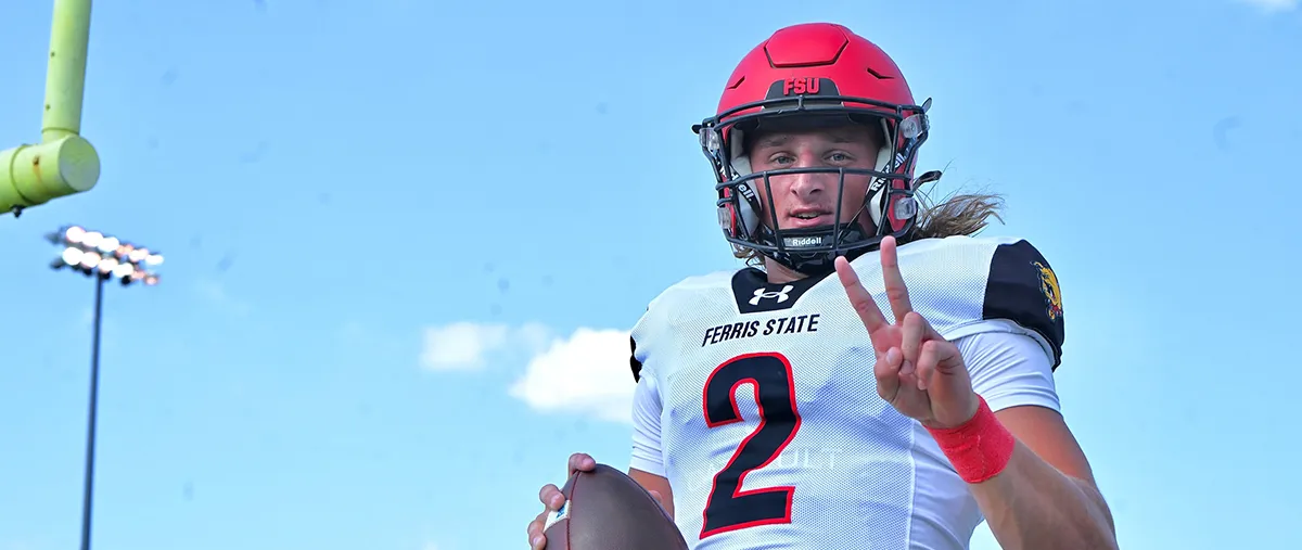 quarterback football player holding up the peace sign