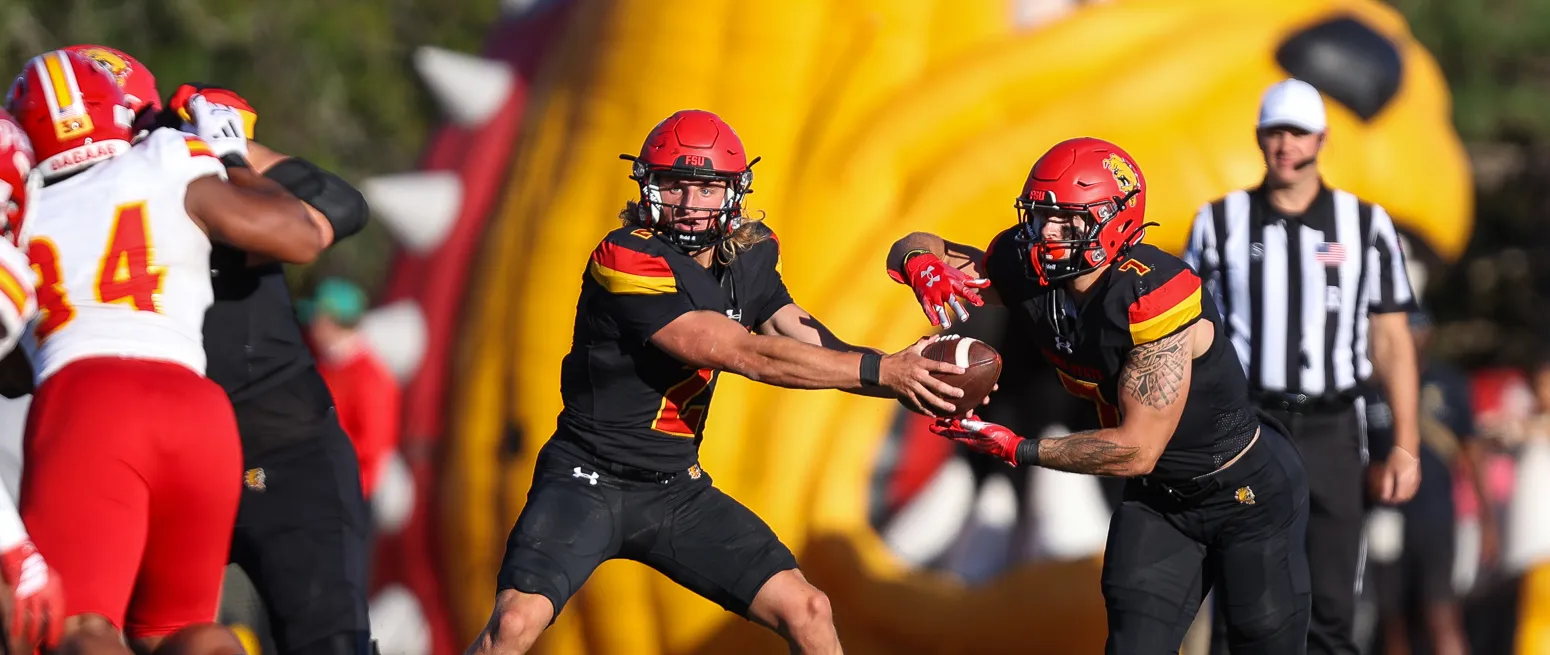 ferris state quarterback passes football to another player