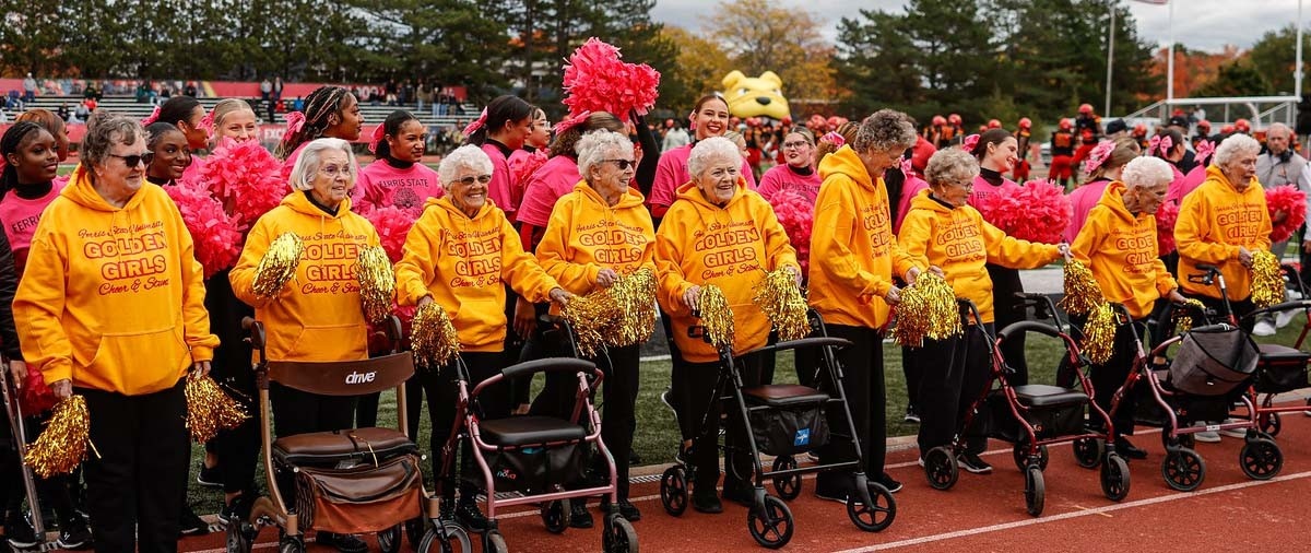 Ferris State's Cheer and STUNT athletes standing with the Golden Girls