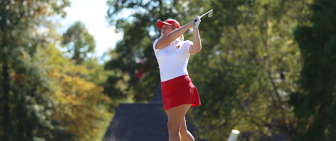 female golfer swinging a golf club