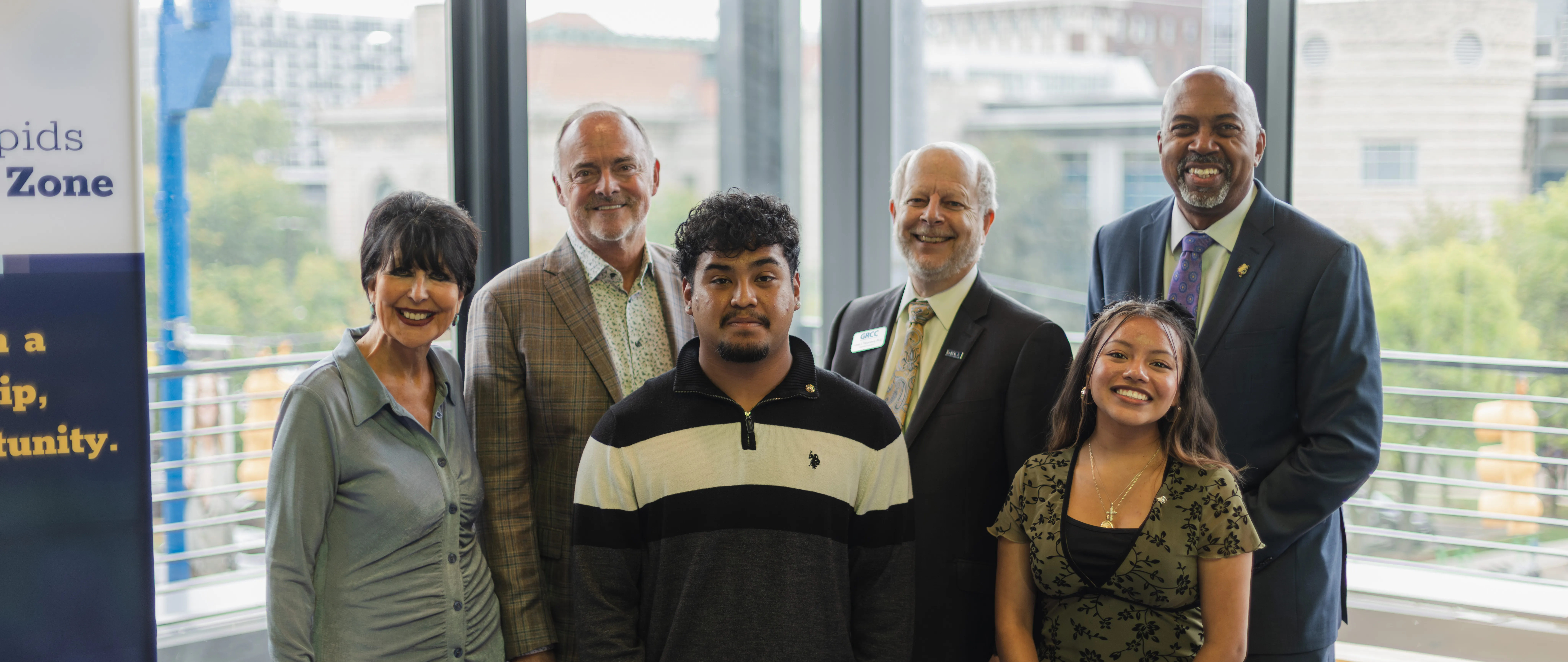 a group photo of the presidents of grcc and ferris state with students from grcc