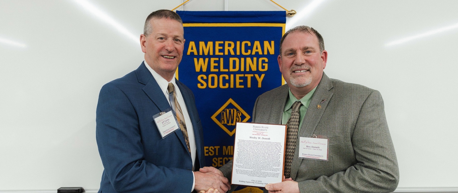 Wes Doneth holding his plaque with Jeffrey Carney, program coordinator of Ferris State’s WET programs
