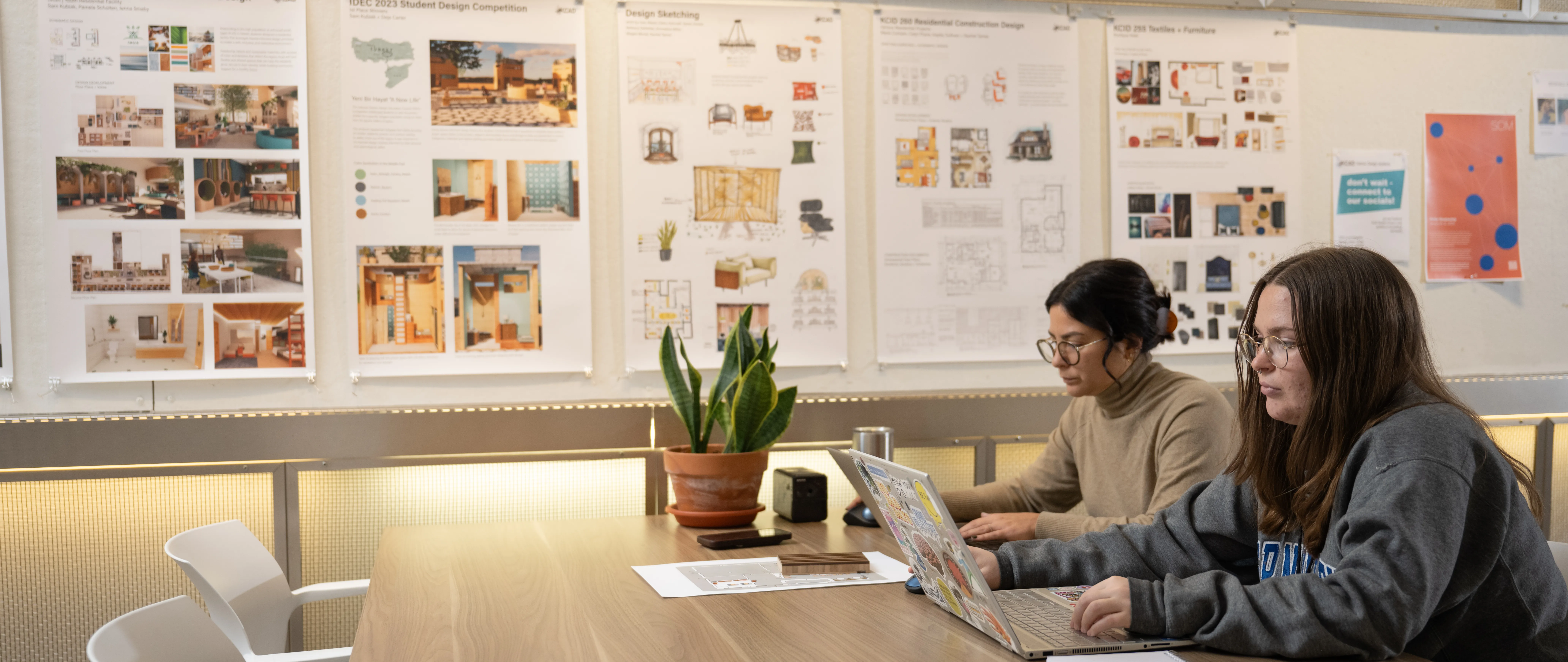 students working with interior design projects on the walls