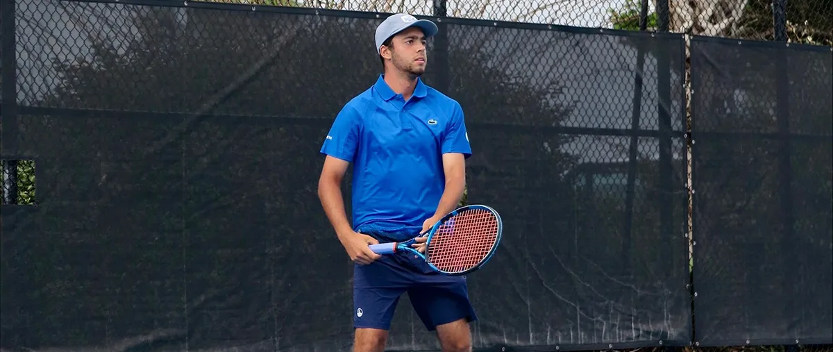 lorenzo pierini holding a tennis racquet on a court