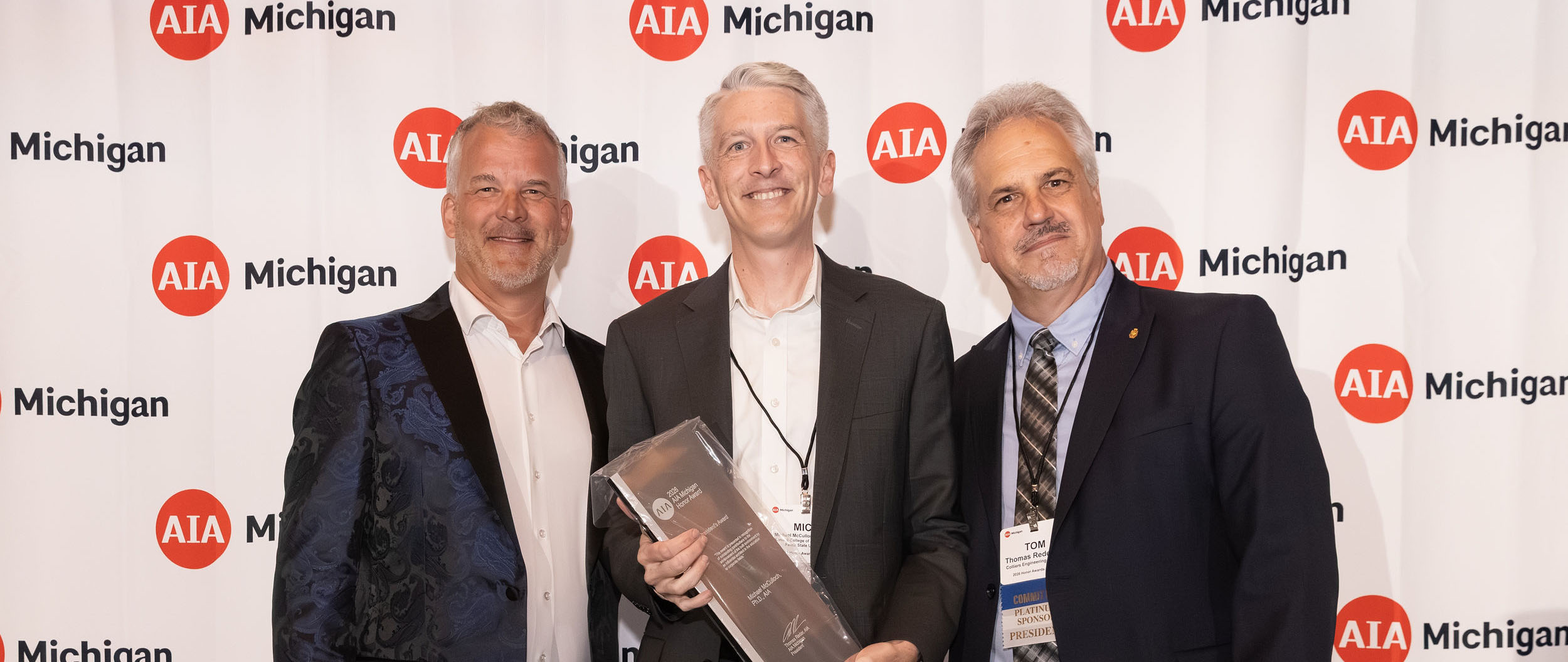 Michael McCulloch (center) receives AIA Michigan's President's Award for 2026.