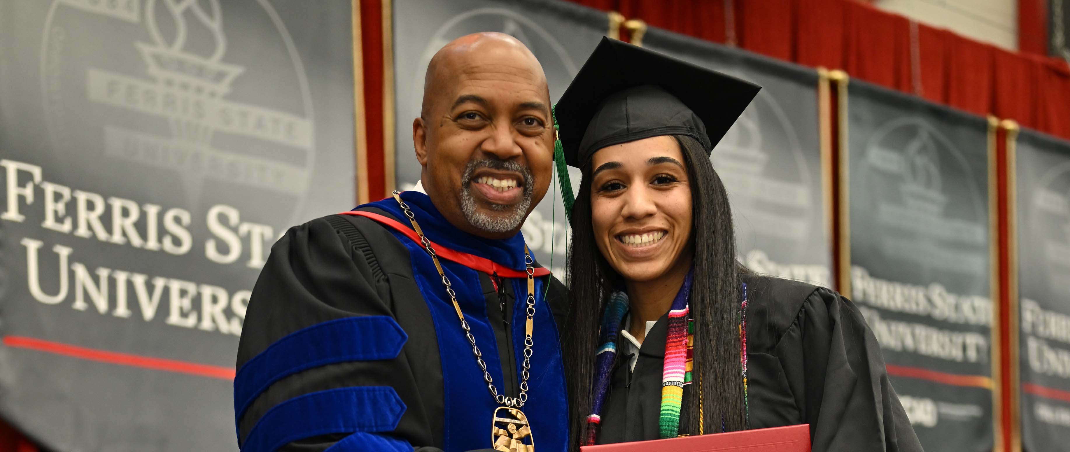 Noel Hernandez poses with President Pink as she receives her degree.