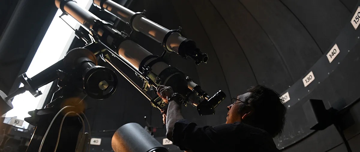 person using a telescope