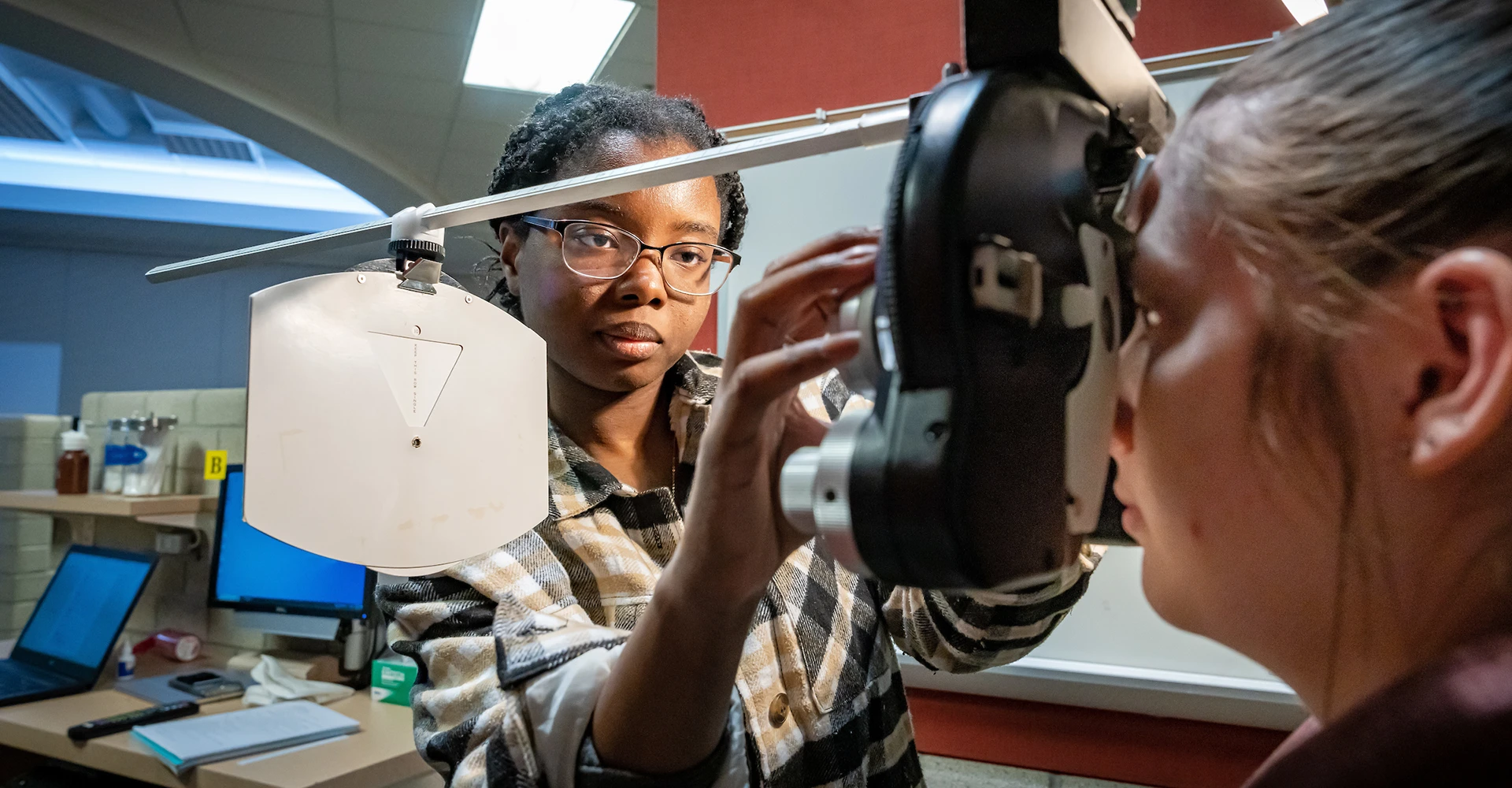 Student completing an eye exam