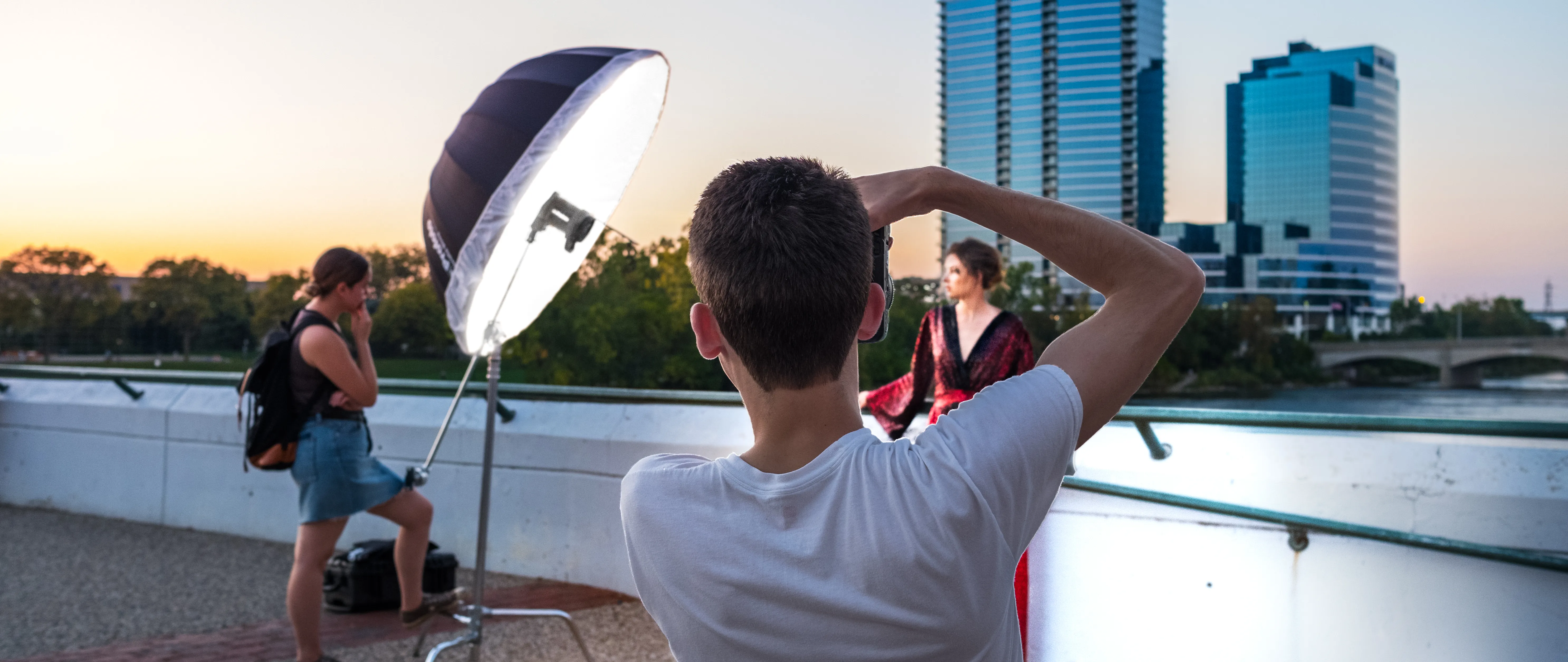 students taking photos outside with photography lights