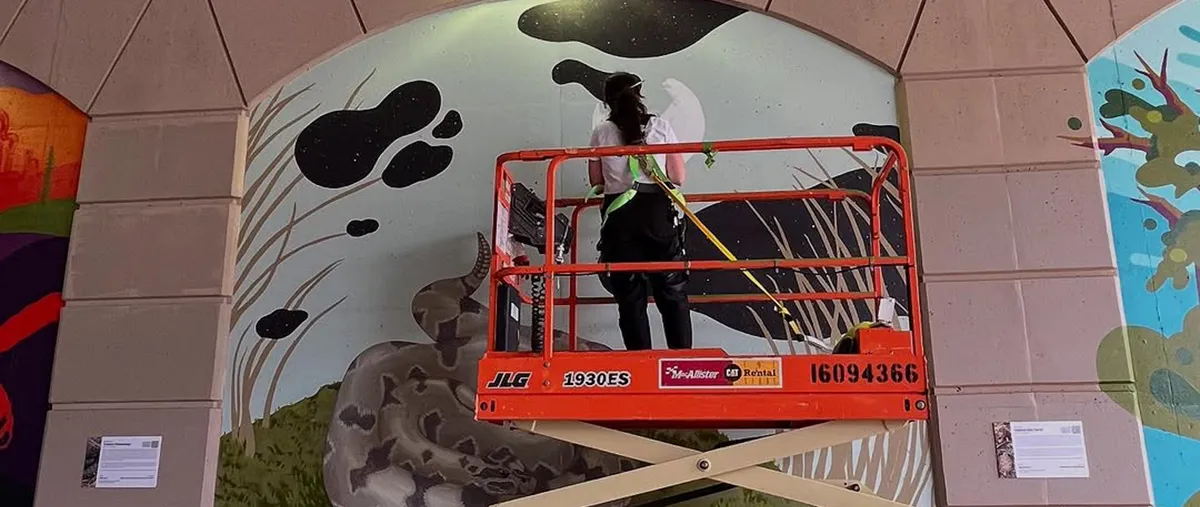 illustration program alum paints mural in downtown Grand Rapids