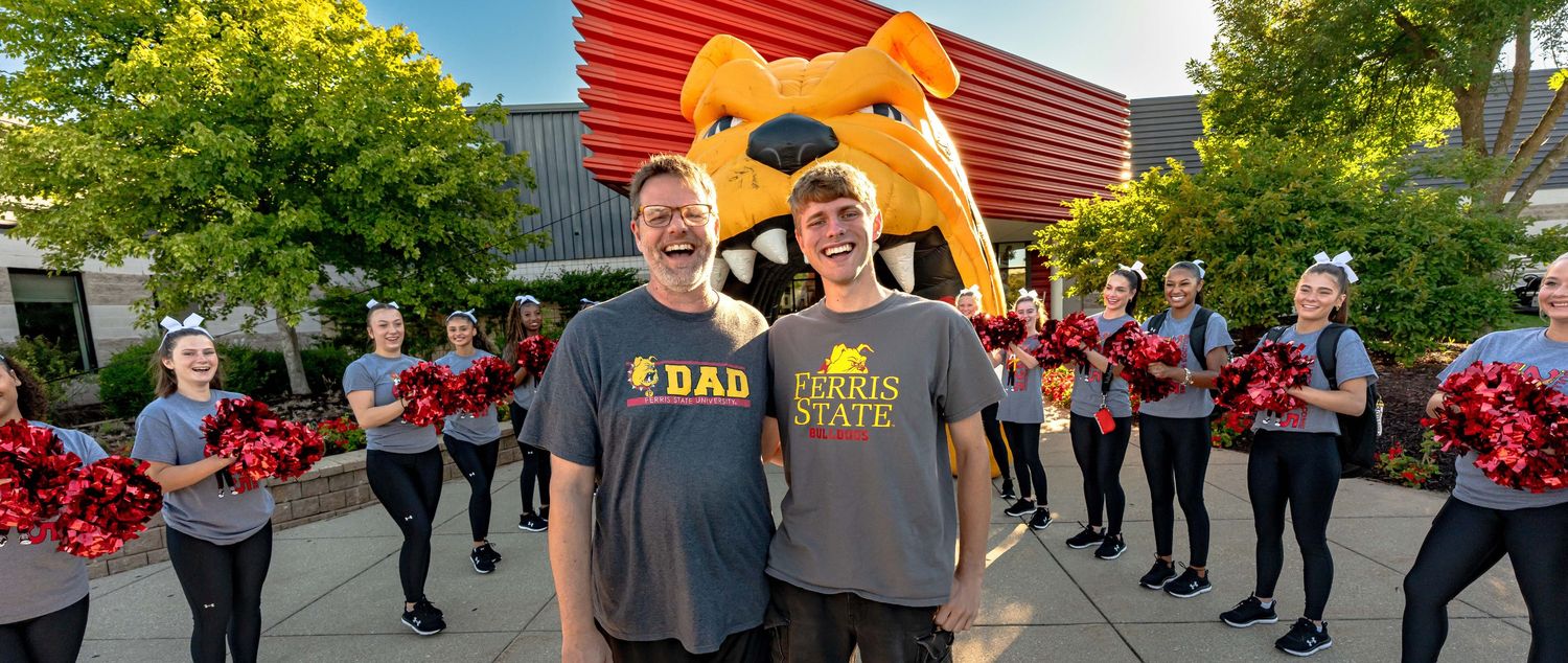 Ferris state student with his father during a pep celebration