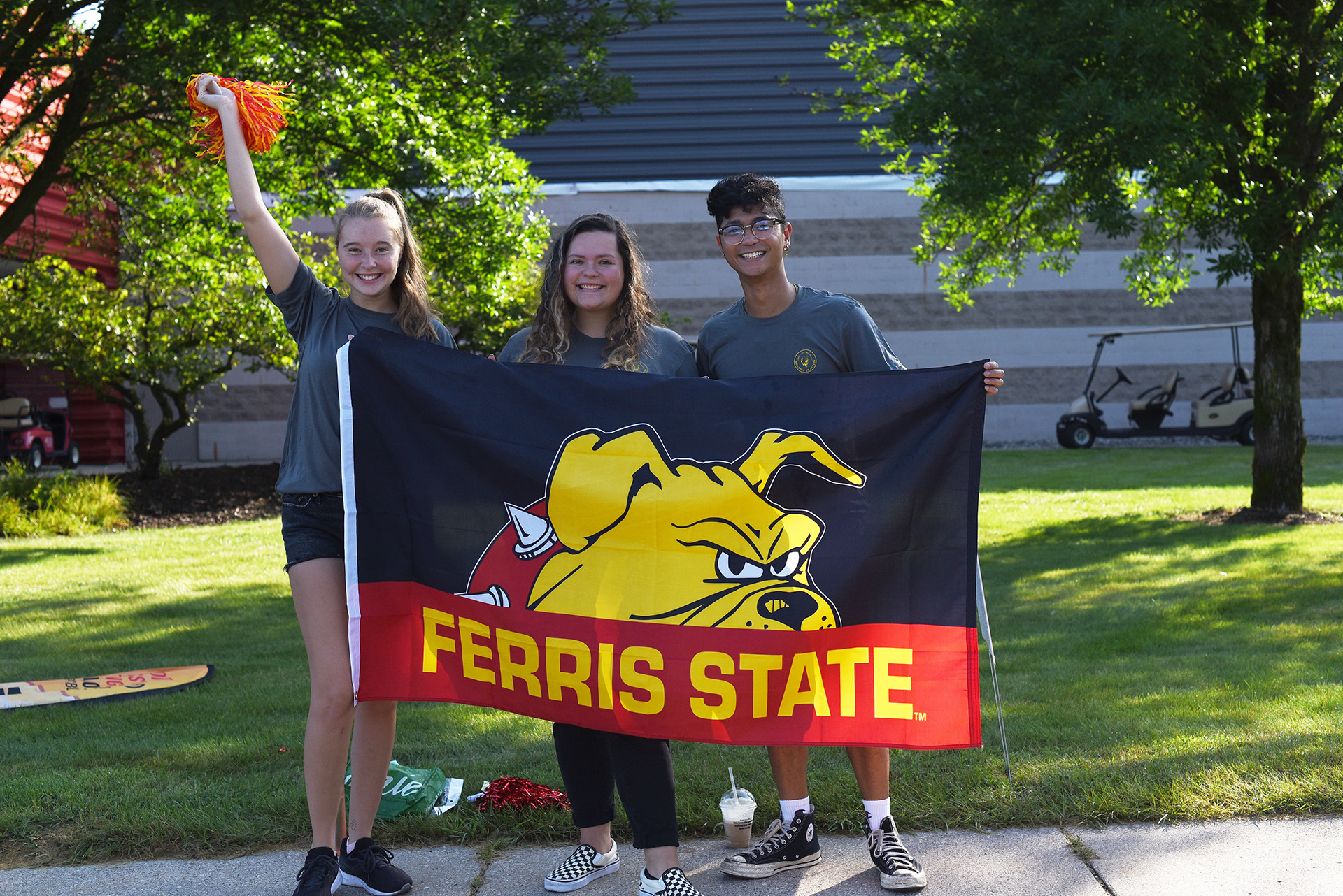 Students with a Ferris State University flag