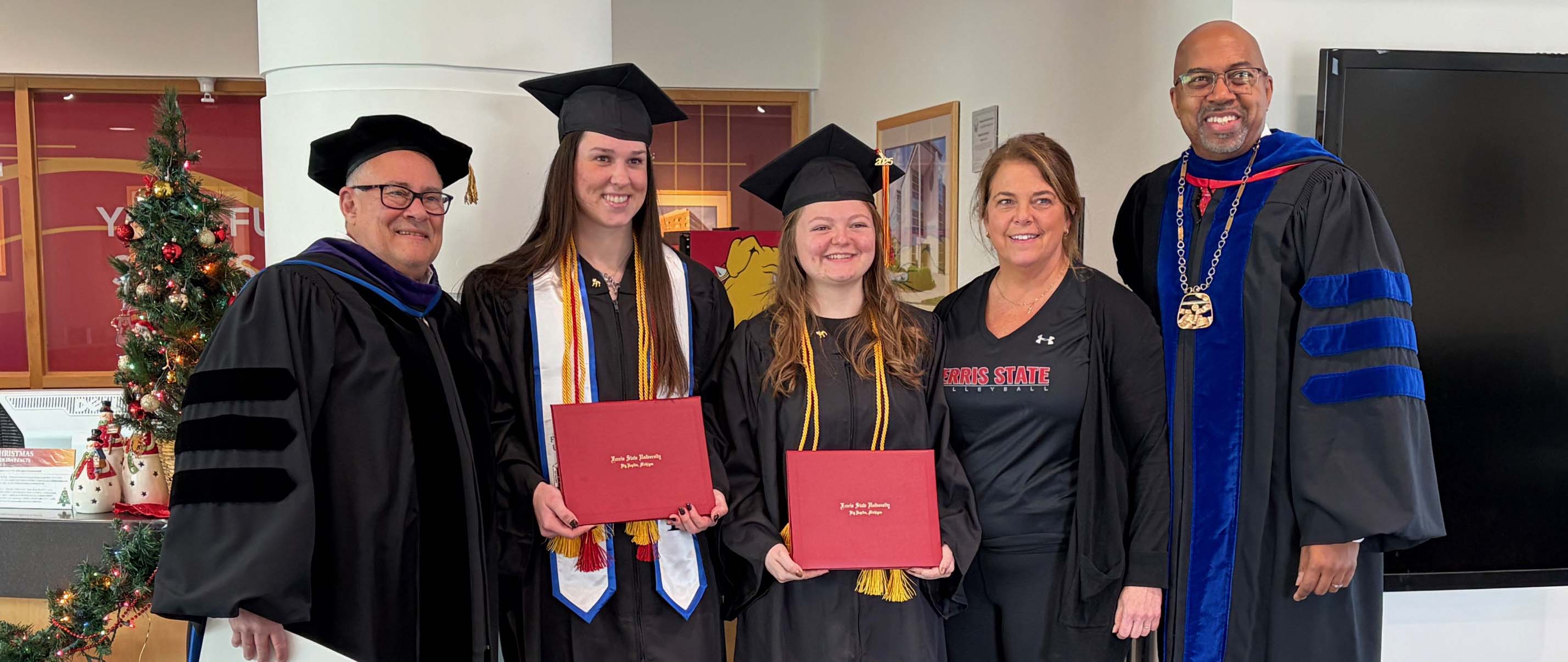 From left to right: photo of Provost Bobby Fleischman, student Emma Bleecher, student Ivy Wilhelm, head coach Tia Brandel-Wilhelm, President Bill Pink
