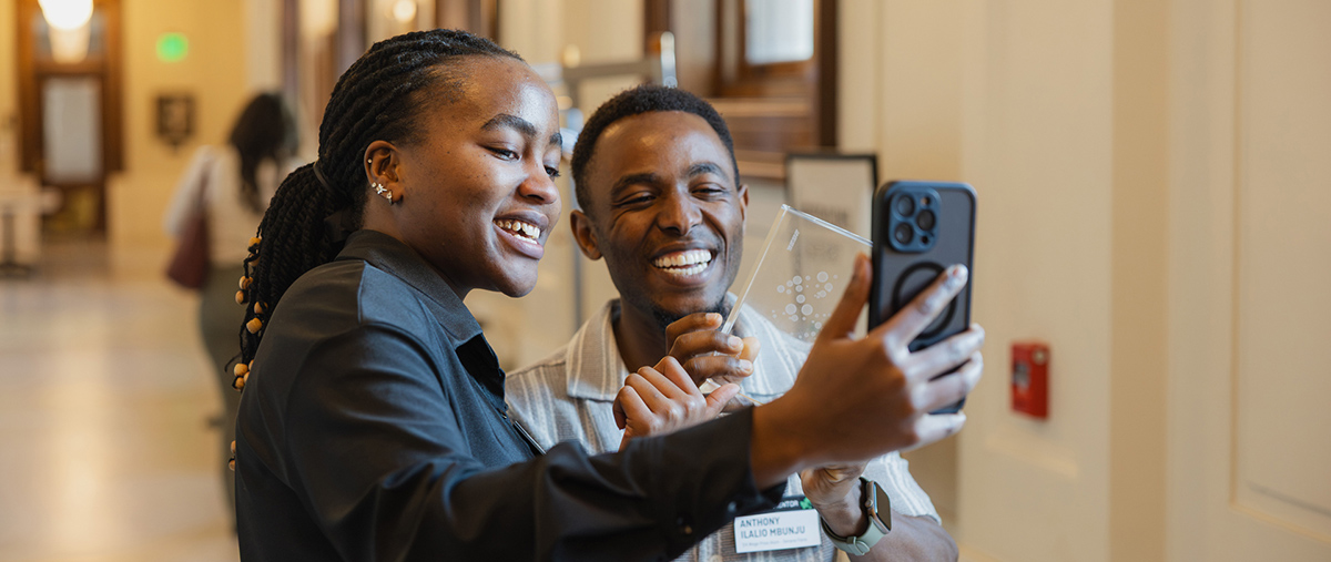 Students taking a selfie with an award.