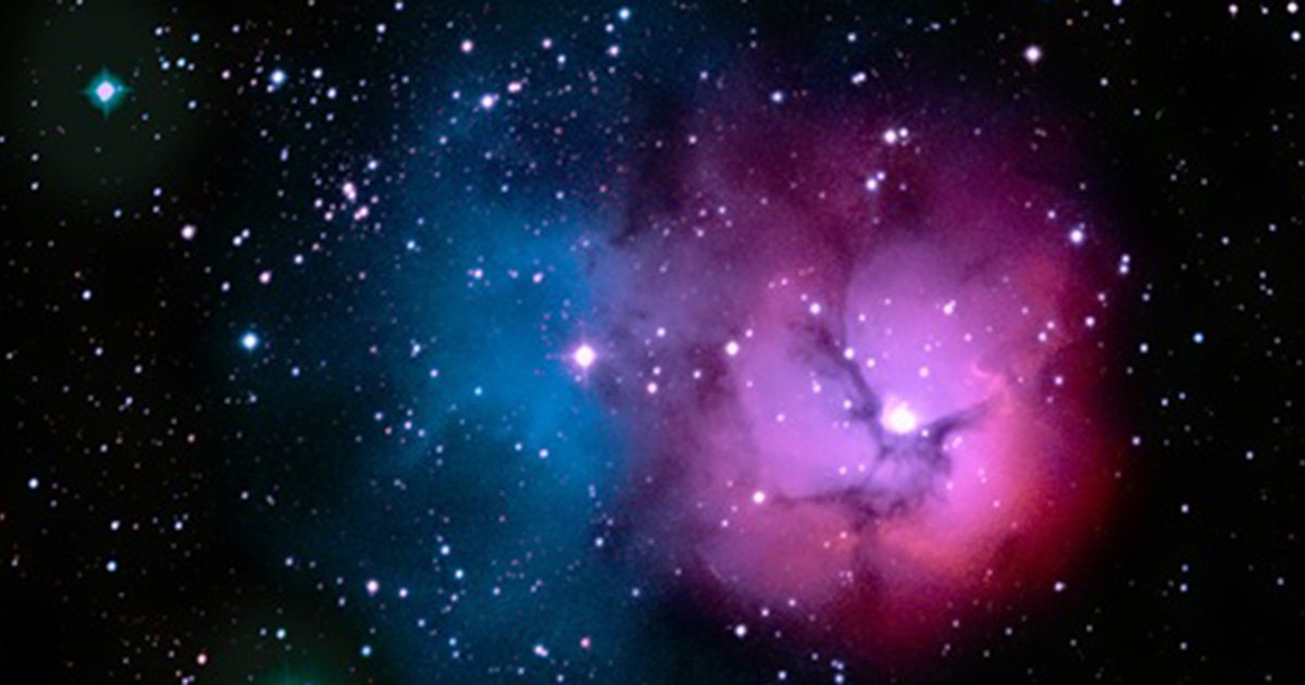 Blue and pink trifid nebula in the night sky