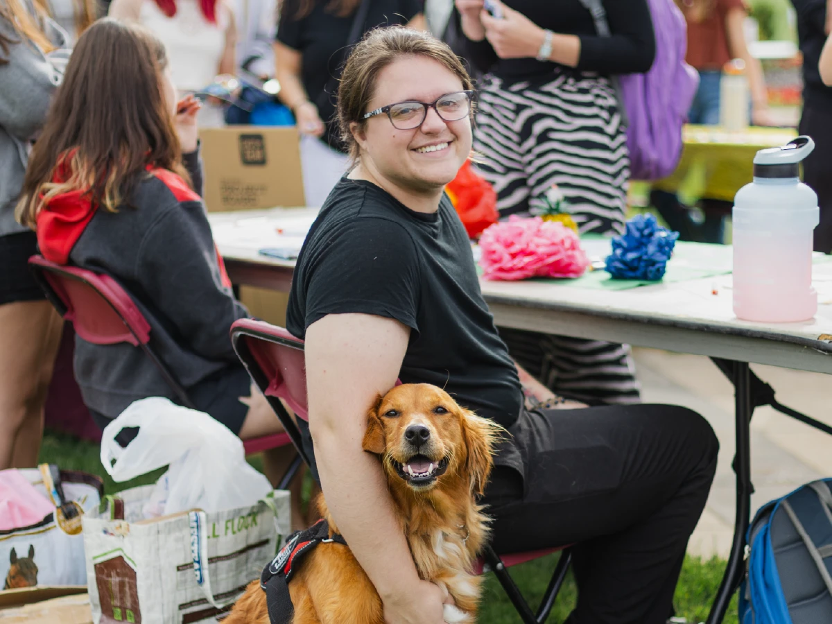 Student and their dog on the campus of Ferris State University