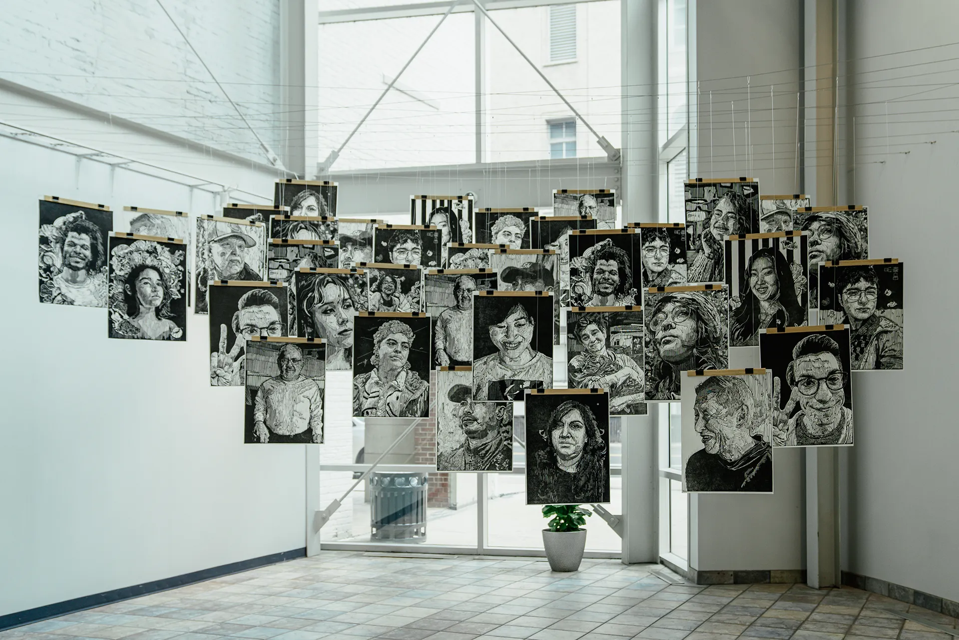Image of illustrations hanging in the atrium of Ferris State University's Kendall College of Art and Design