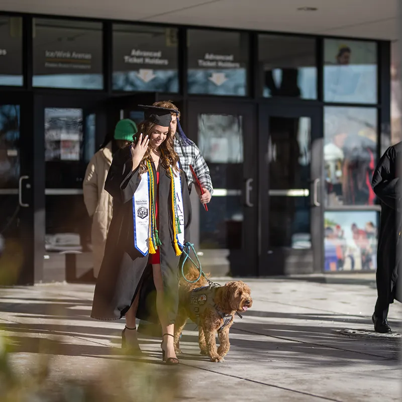Lily Degroot and her service dog at commencement