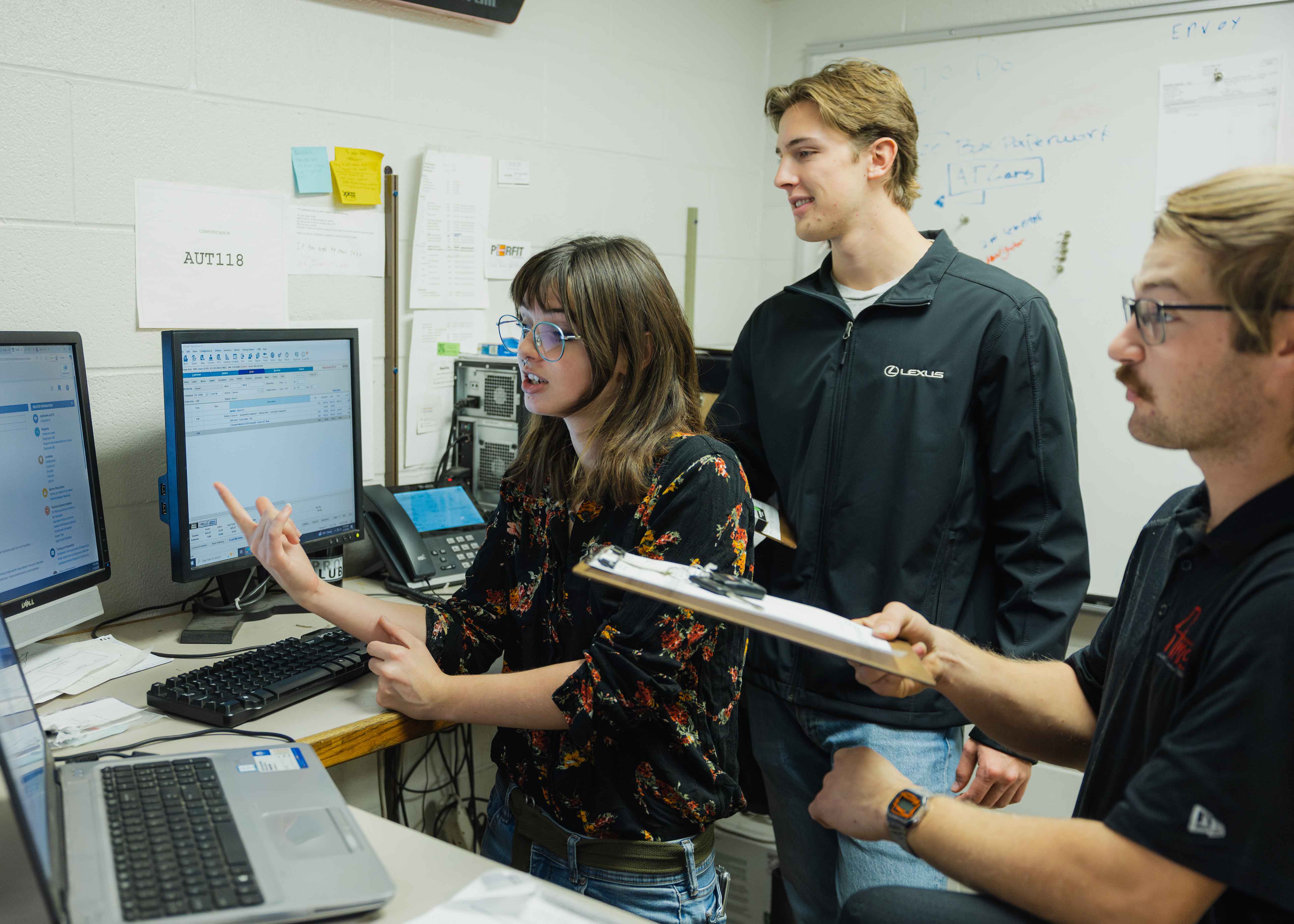 students standing around computers pointing