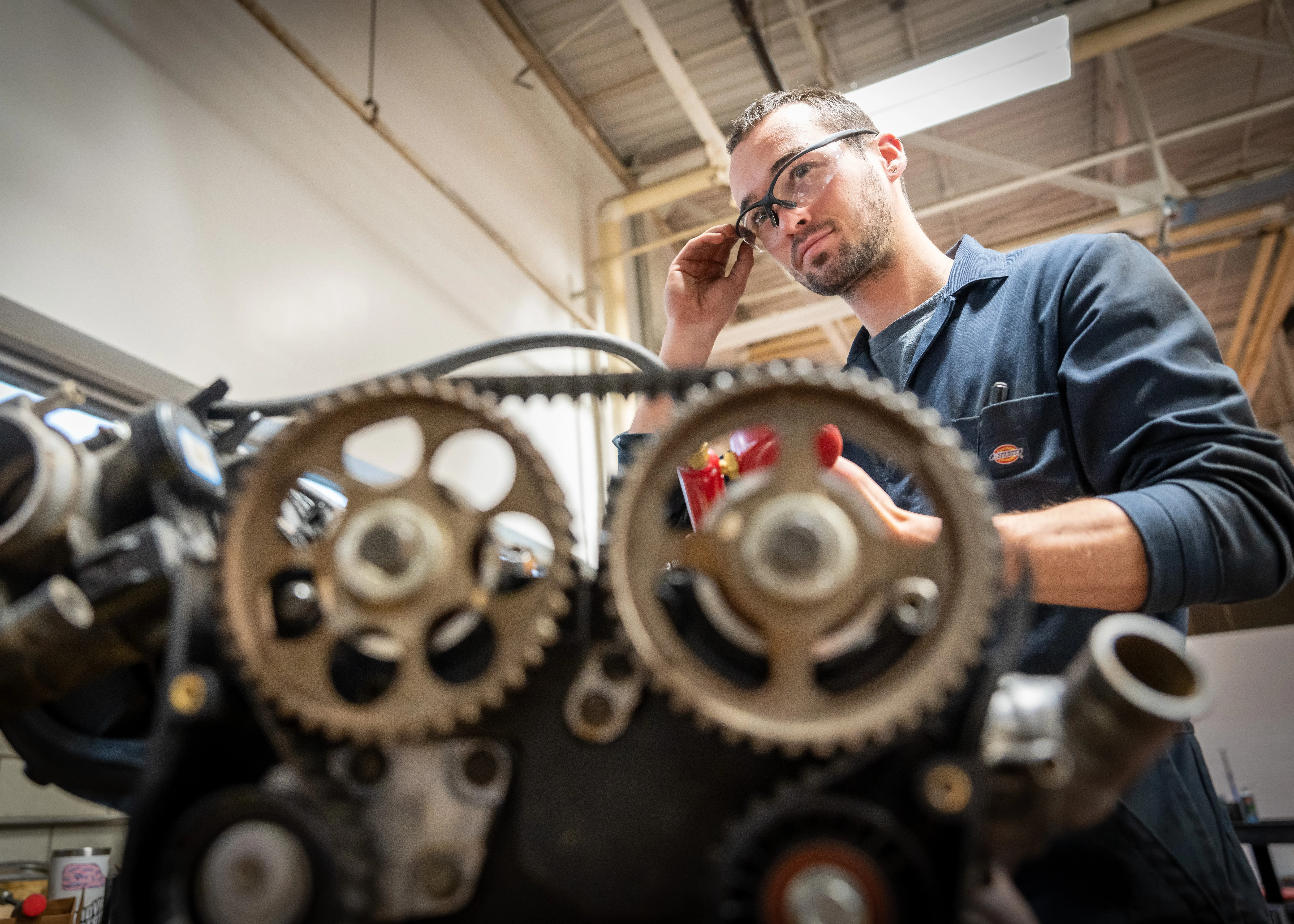 automotive management students in a body shop