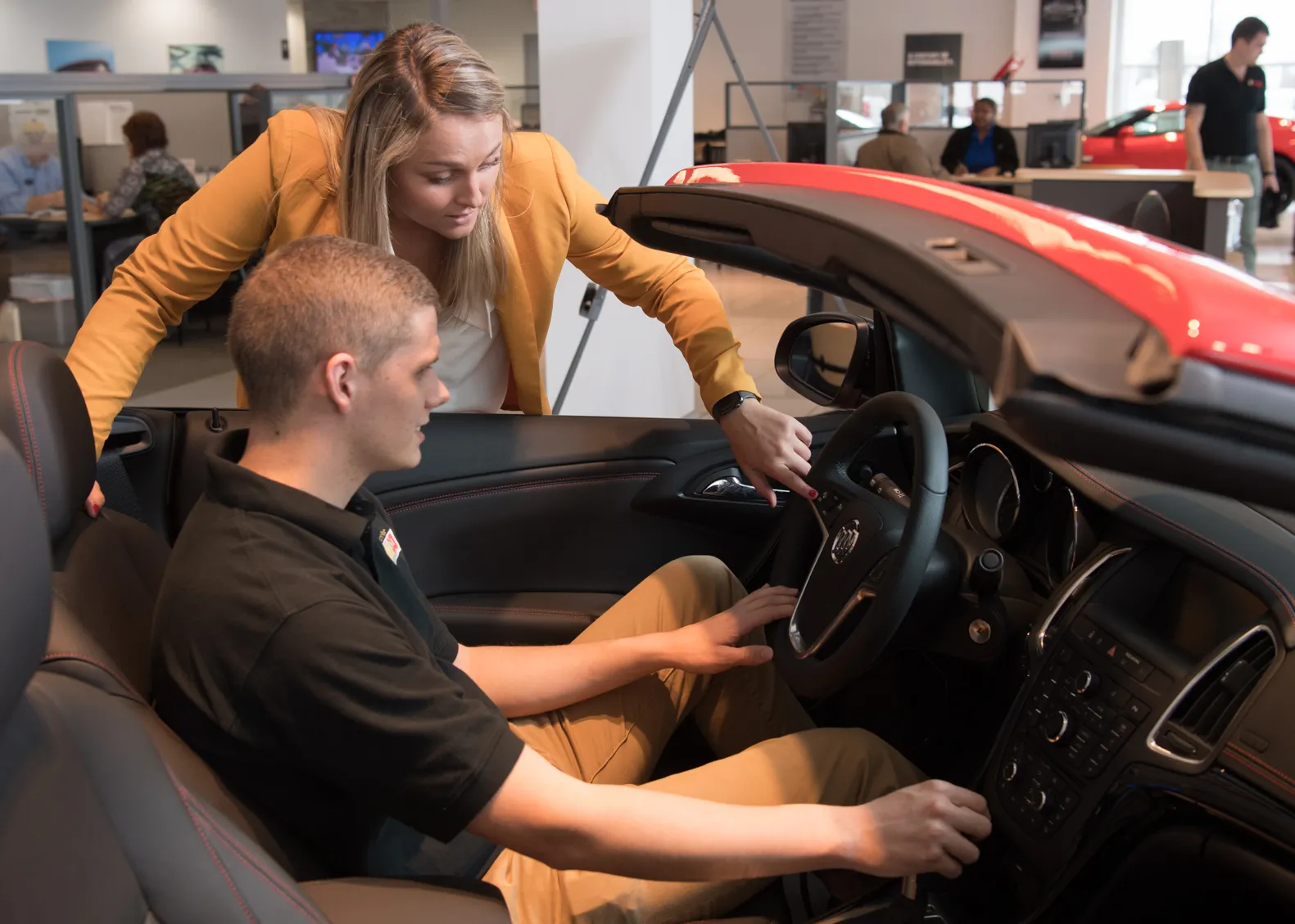 student showing another student a car's features