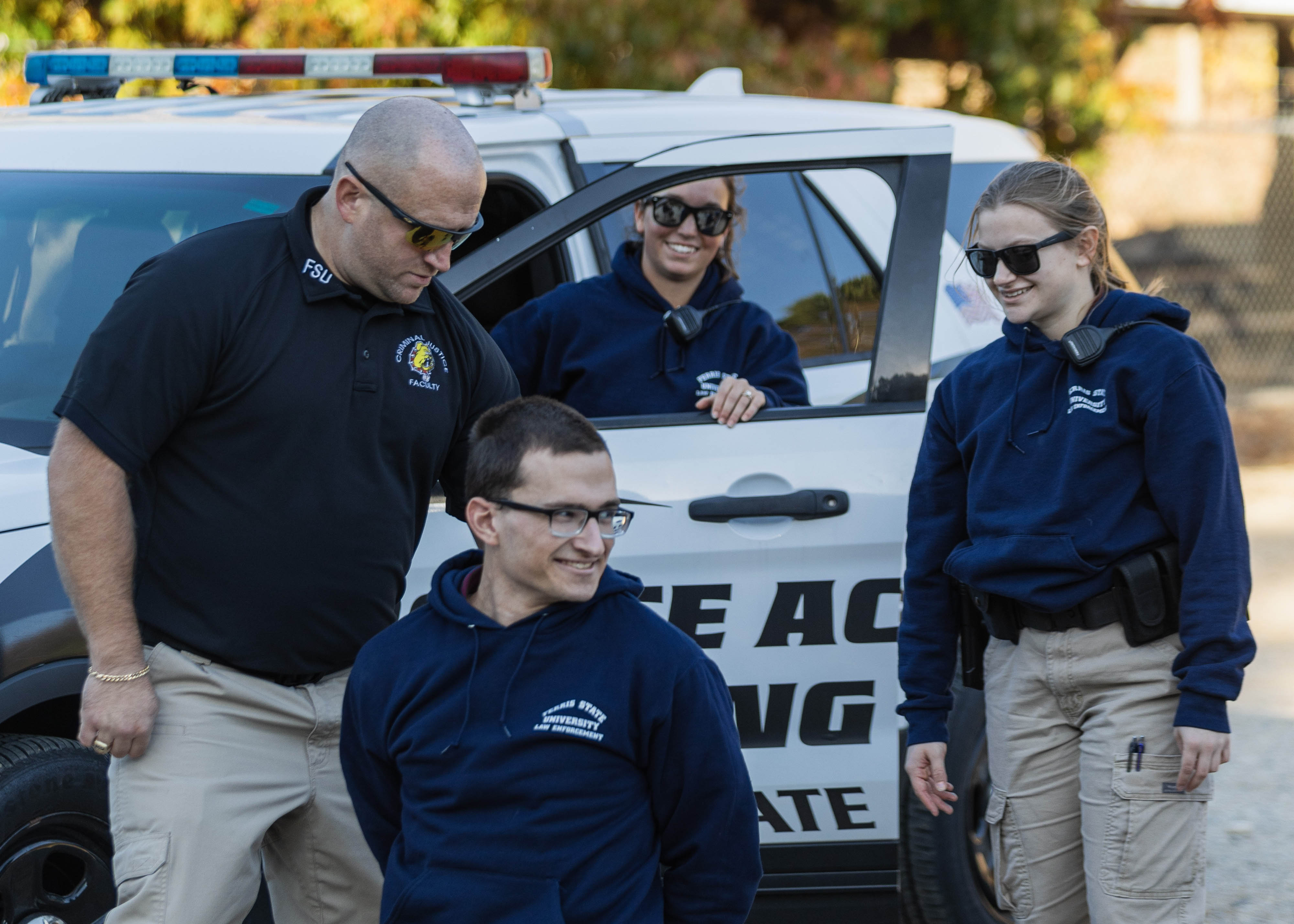 students in the field practicing police activities