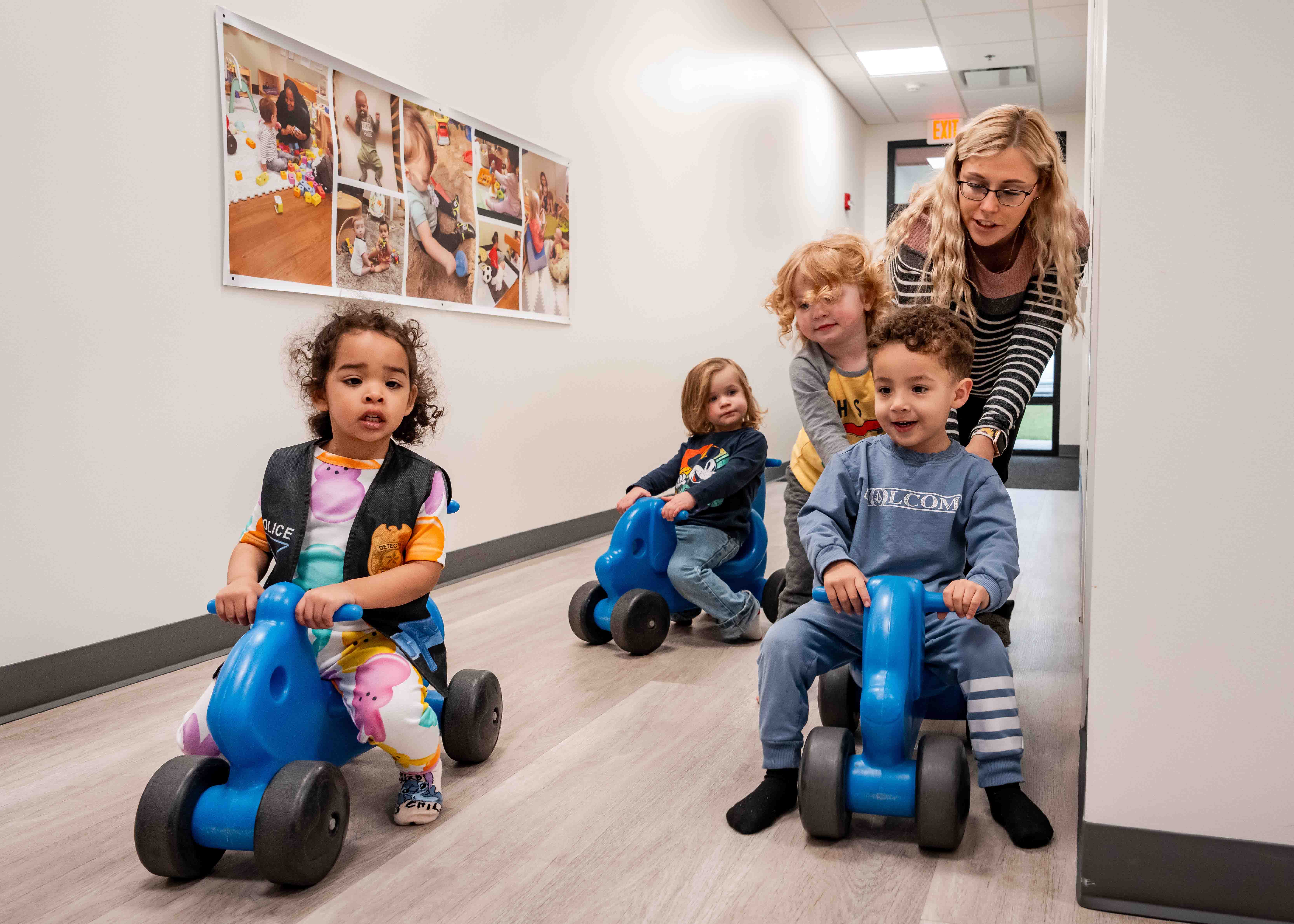 children on tricycles in a hallway