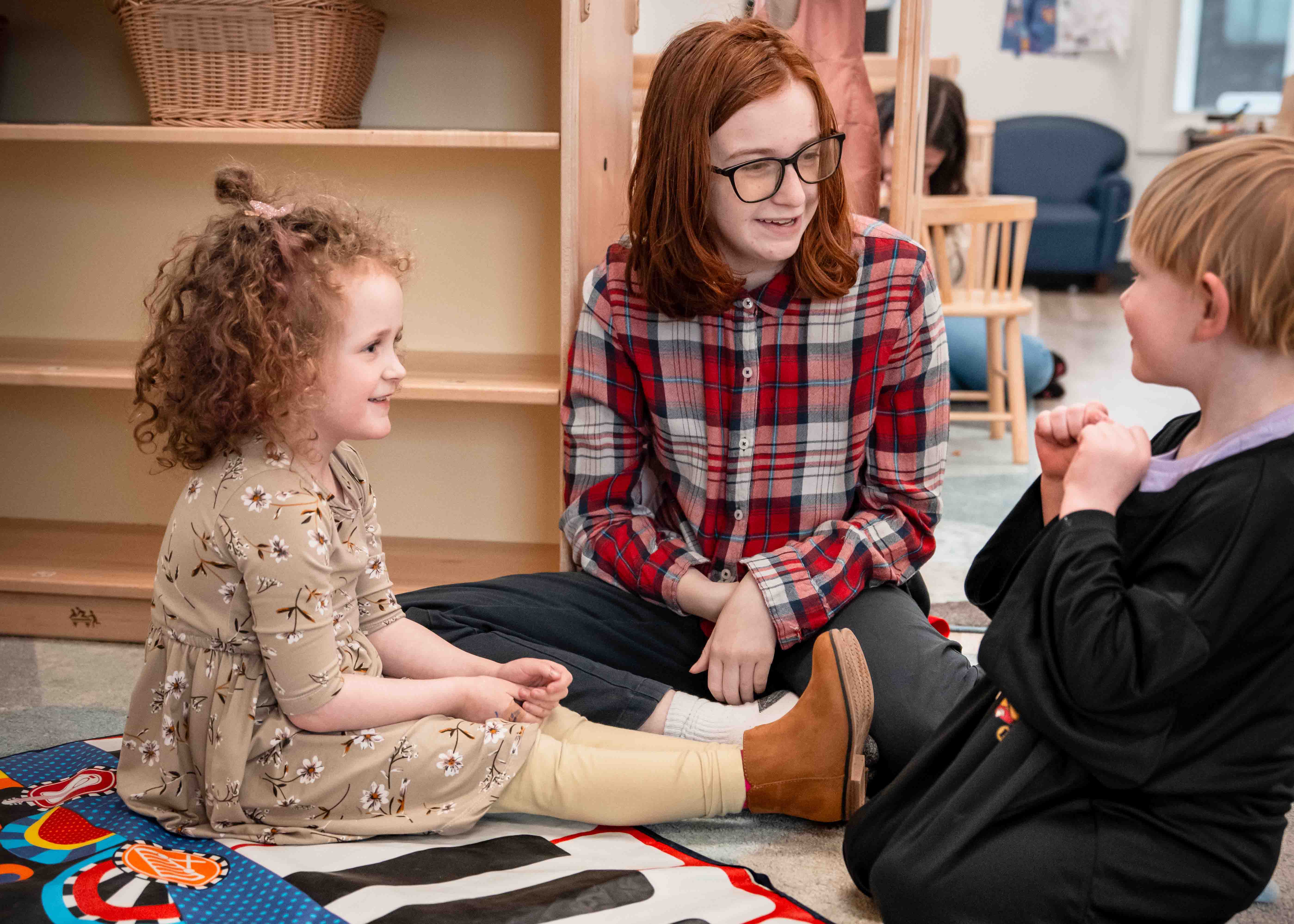 student in early childhood room with a child