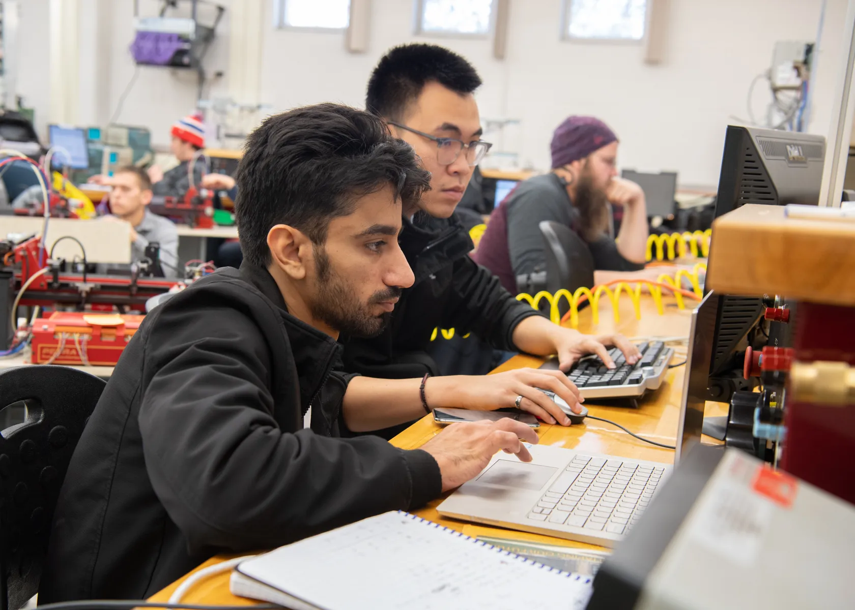 students in a classroom working on automation programming