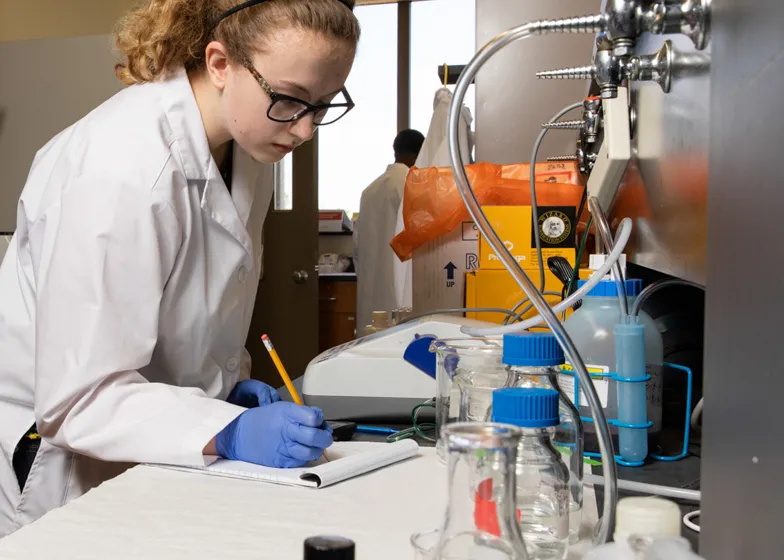 Student working in a chemical lab setting