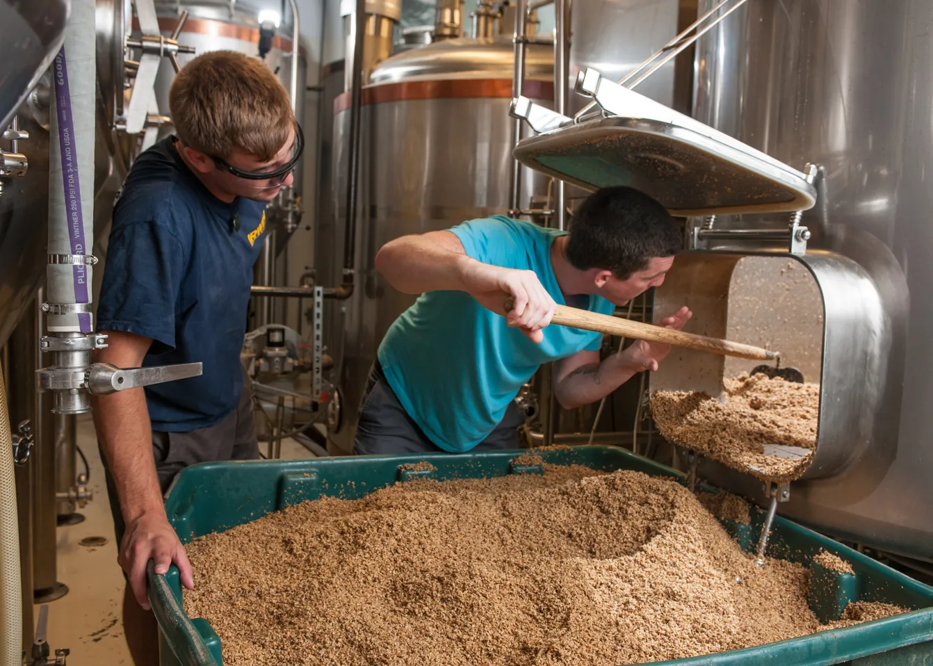 students working with industrial chemsitry fermentation equipment